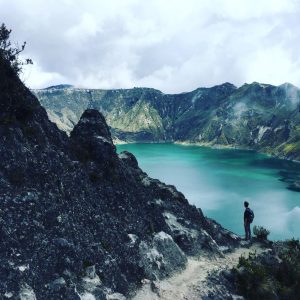 Man and a rock at Quilotoa lake Ecuador
