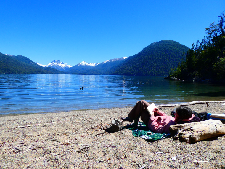 Anna drawing close to the lake, with the mountains in the distance
