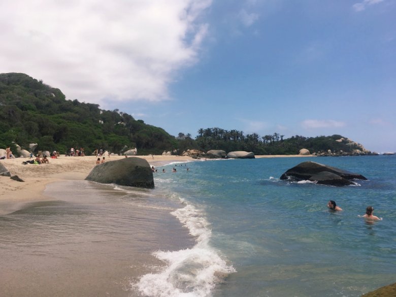 Playa Arenilla with people swimming