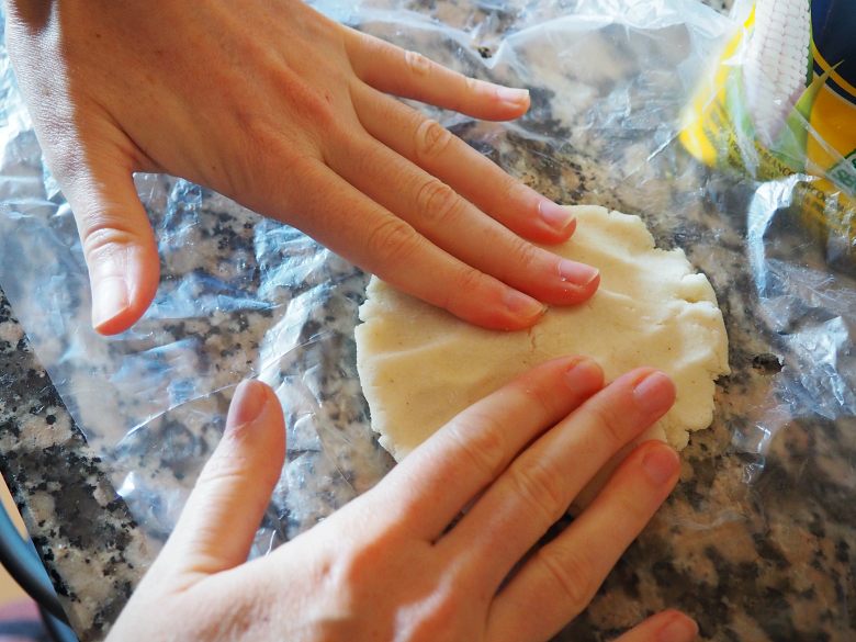 Arepas flattening with hands