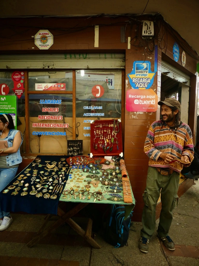 Craftman is selling his jewely on Otavalo market in Ecuador